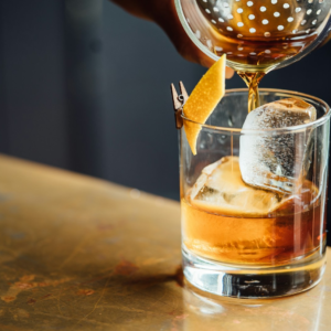 liquor pouring on clear shot glass
