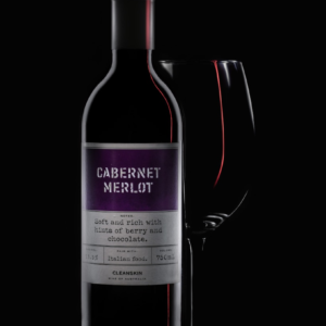 a bottle of cabernet merlot next to a wine glass
