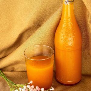 orange liquid in clear drinking glass