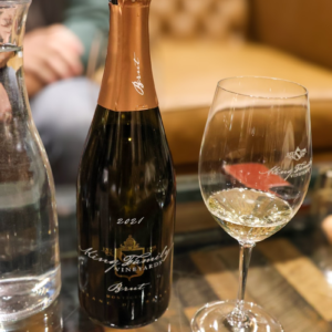 A glass of wine and a bottle of wine on a table